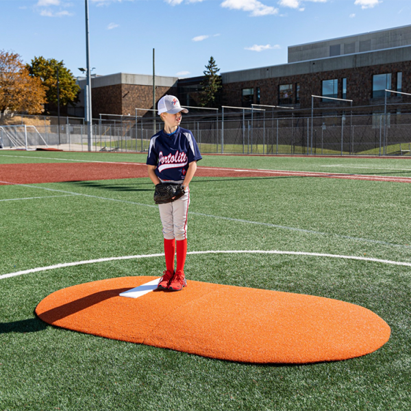 The Portolite 6” Two Piece Game Mound is perfect for players 14 and under, featuring tapered edges, durable turf, and lightweight 60 lb sections for easy portability