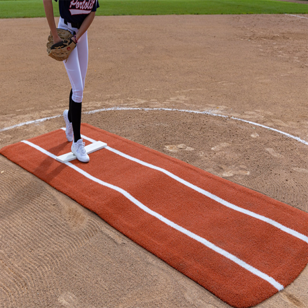Portolite’s Ultimate Practice Mat measures 11’ x 3’ with 5,000 spikes offering a stable, slip-free surface for softball pitchers of all levels on any field